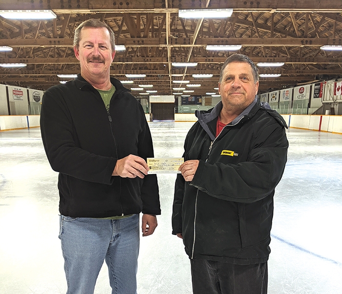 Allan Holloway, right, presented a cheque in the amount of $8,036.54 to the town of Wapella on Tuesday. The cheque was the proceeds from the Dakota Holloway Memorial Hockey Tournament held on Jan. 24 and will be used for the Wapella Rink. Deputy Mayor Brian Schinke, left, accepted the cheque.