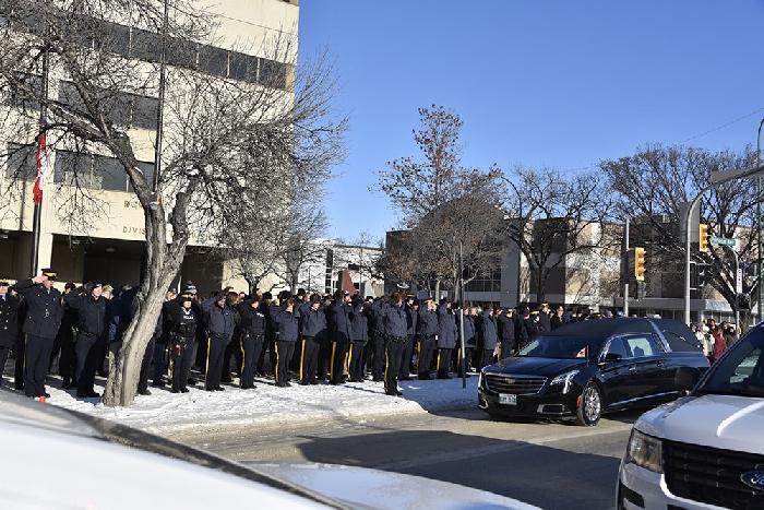 A moment of silence was held for Cst Allan Poapst Tuesday, as the motorcade paused in front of the Manitoba RCMP Headquarters and gave all employees a chance to pay their respects.