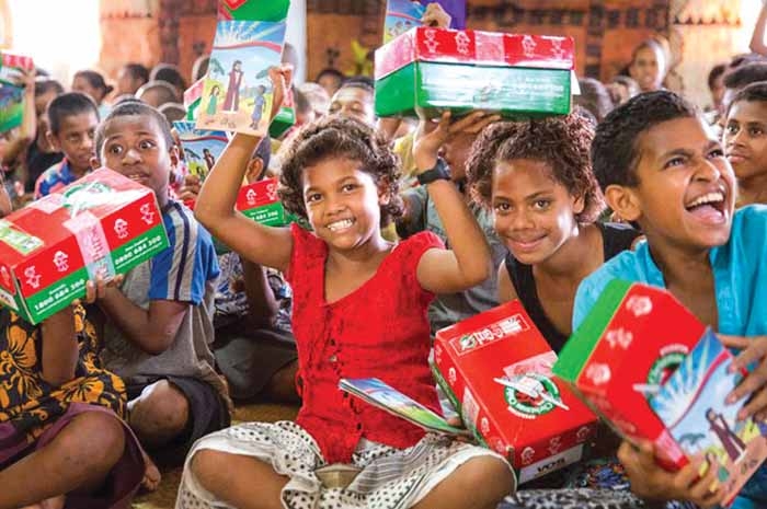 Children receive shoeboxes through Operation Christmas Child.