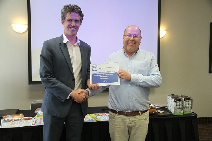 Michael Murray of Block Talk, presents Chamber Secretary Kevin Weedmark with a certificate acknowledging that Moosomin is now on Block Talk.