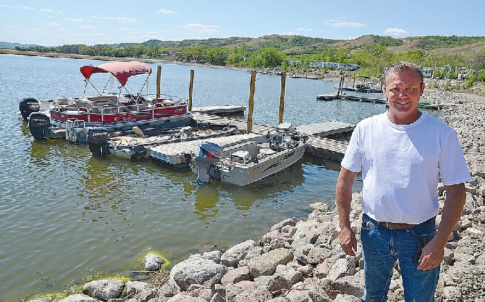 Willie Kuzub in front of the new marina he has developed at his West End Resort on Round Lake.