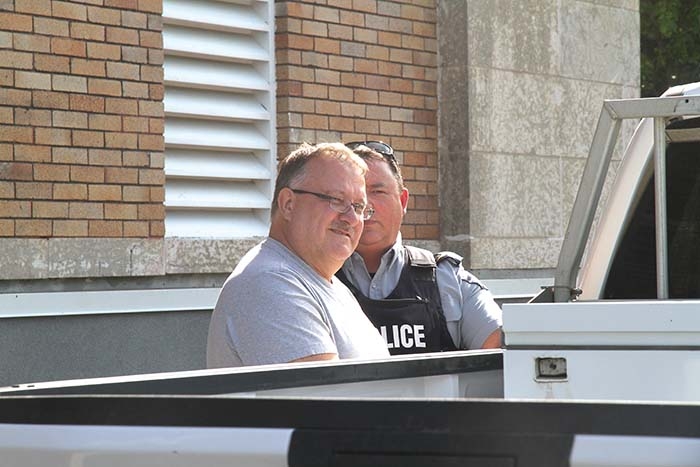 Gregor Gmerek is led out the back door of the Yorkton Court of Queens Bench courthouse Tuesday afternoon to be taken to prison. Gmerek was given two four-year penitentiary sentences, for fraud and forgery, to be served concurrently. He was led out of the courtroom in handcuffs following the sentencing.