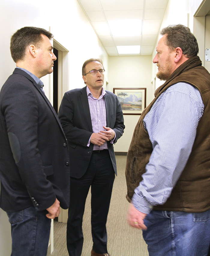 Moosomin MLA Steven Bonk, left, and Health Minister Jim Reiter, centre, discuss health issues with Dr. Wessell Roets at the Moosomin Family Practice Centre Monday.