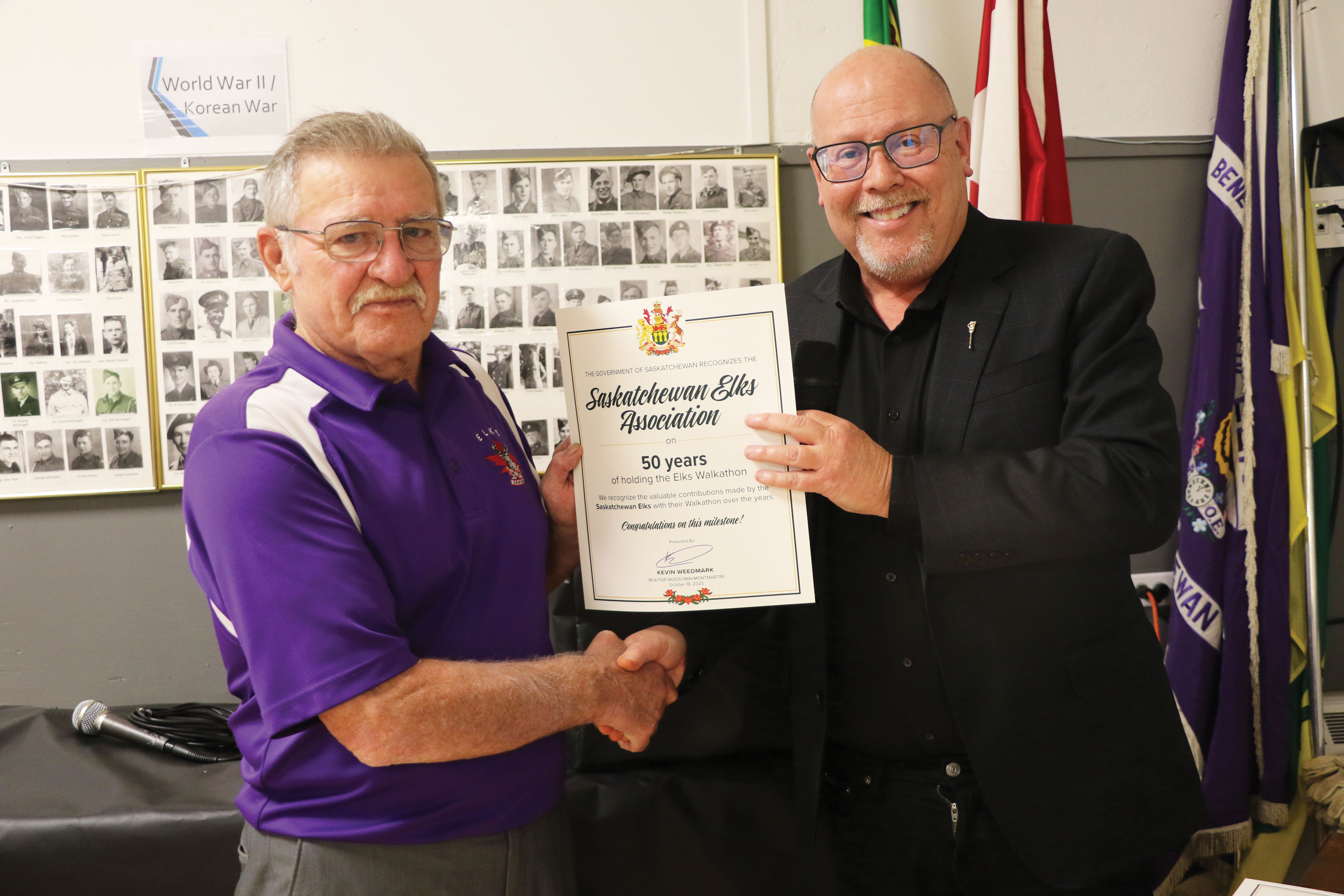 Moosomin-Montmartre MLA Kevin Weedmark congratulating Elks Walkathon Chairman John Voutour from Kisbey on 50 years of the Saskatchewan Elks hosting the Elks Walkathon.