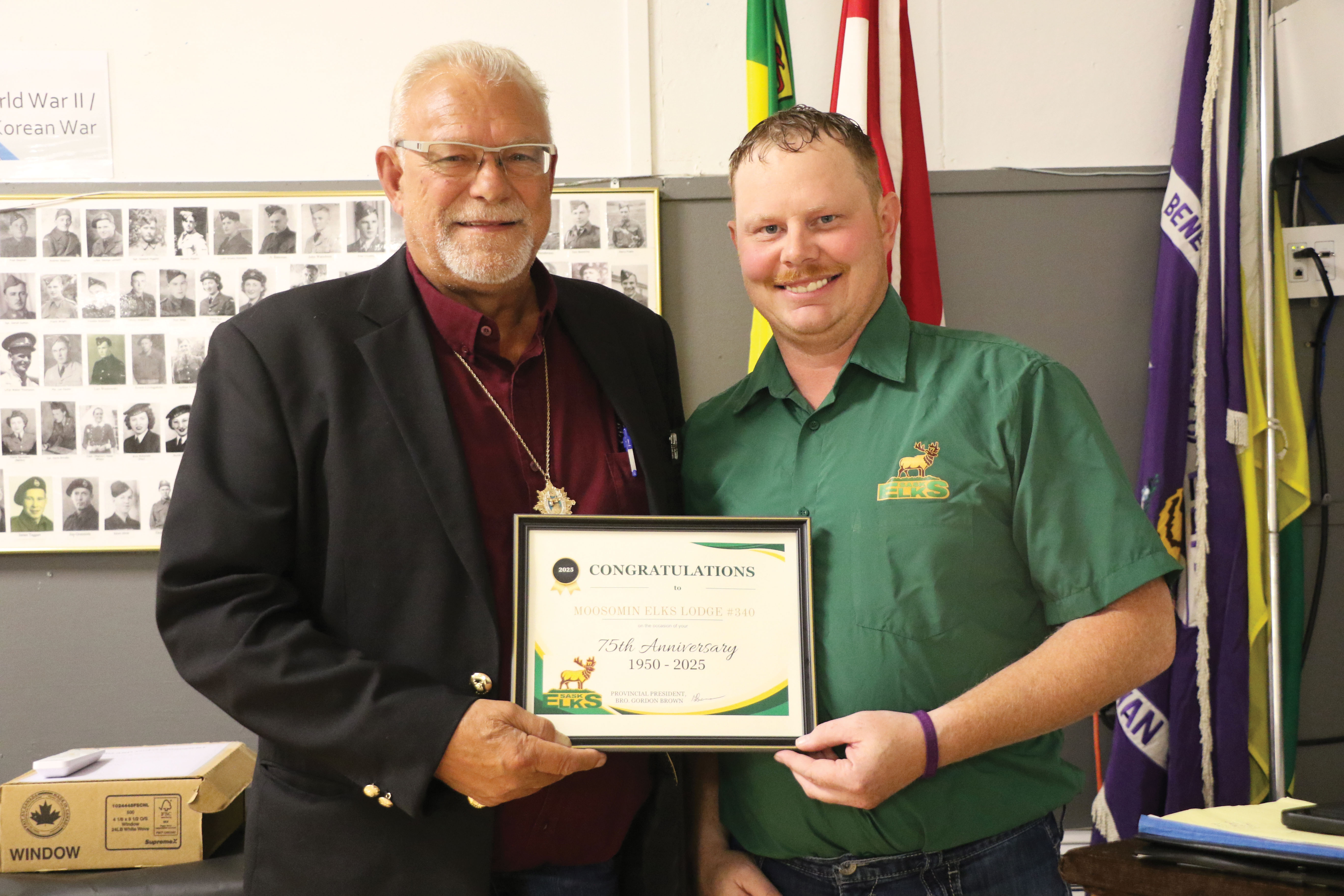 Saskatchewan Elks President Gordon Brown from Shaunavon congratulating Moosomin Elks President Ron Potter on the Moosomin Elks 75th anniversary.