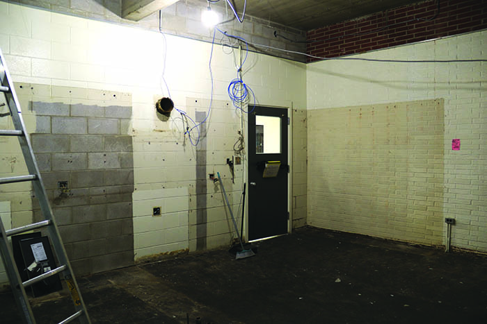 The empty kitchen space in Home Ec Lab. At right in the photo, the original brick exterior of the school can be seen.<br />
