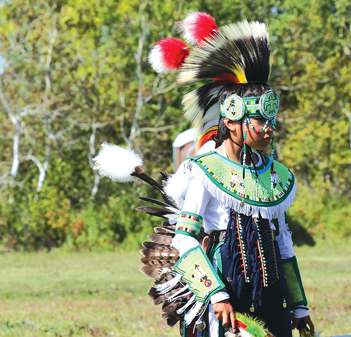 Tyman Whitebear dressed in traditional Indigenous regalia.