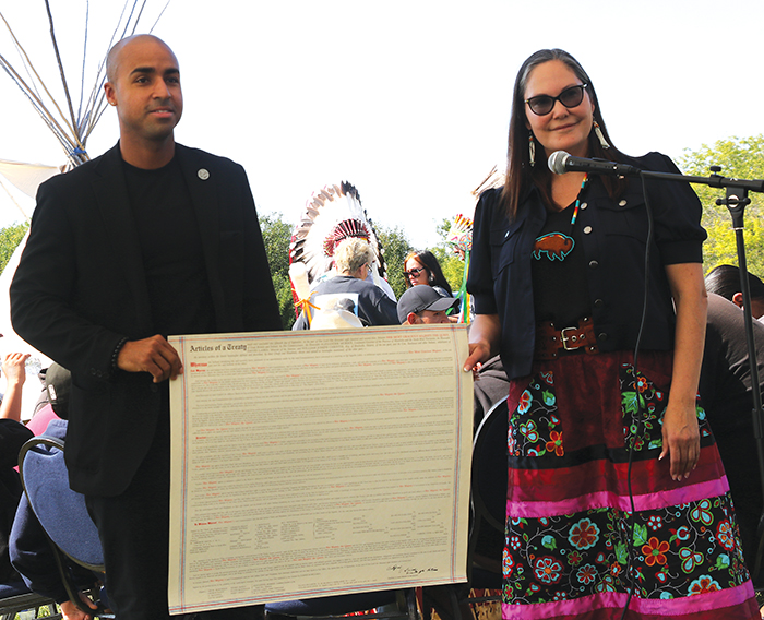 Ocean Man councillor Justin Holness and Treaty Commissioner of Saskatchewan, Kathy Walker, holding a copy of Treaty 4.<br />
