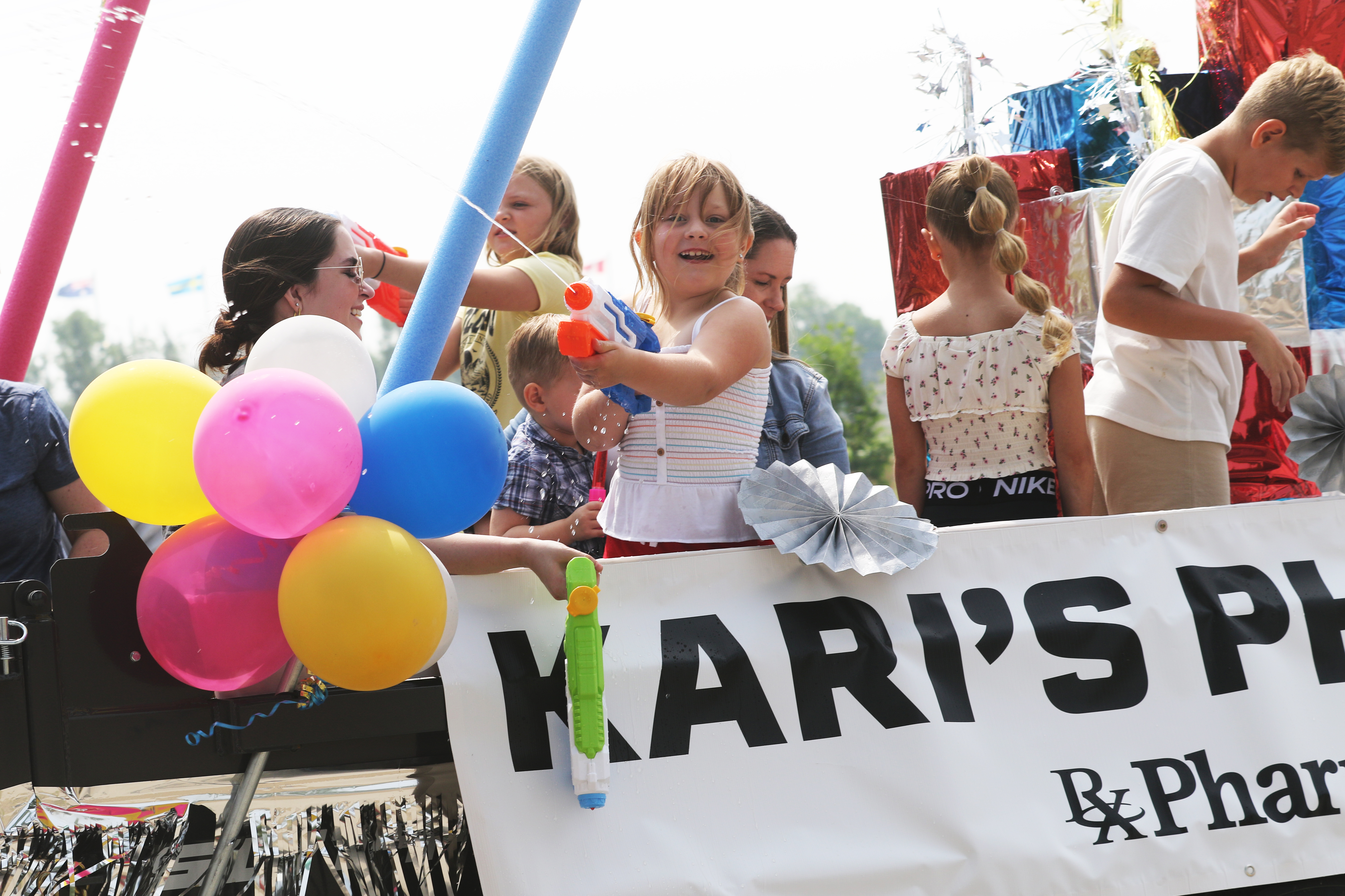 Children blast water guns off a float during last year�s Chamber parade.