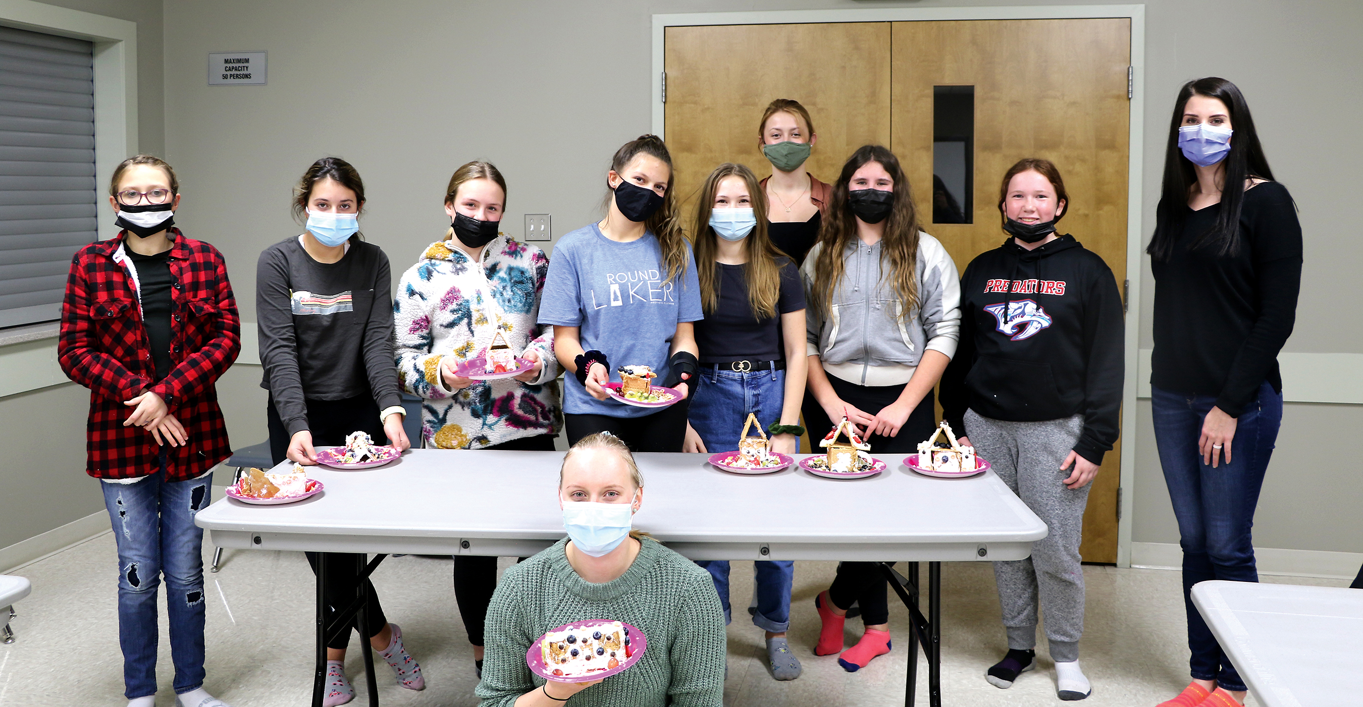 At this month’s HER Girl Club’s event hosted by Class with Cass Holistic Nutrition, the girls made healthy ginger bread houses. Left: Maya McMullen, Tess Nagy, Myla Woods, Kendall Shipp, Macy Rushton, Paige Hutchinson, Miley Bell and Jaz Koroscil, Kassidy Robidoux and Lauren van Dyke (bottom).
