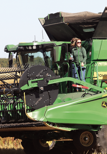 Volunteers climbing into the combine.