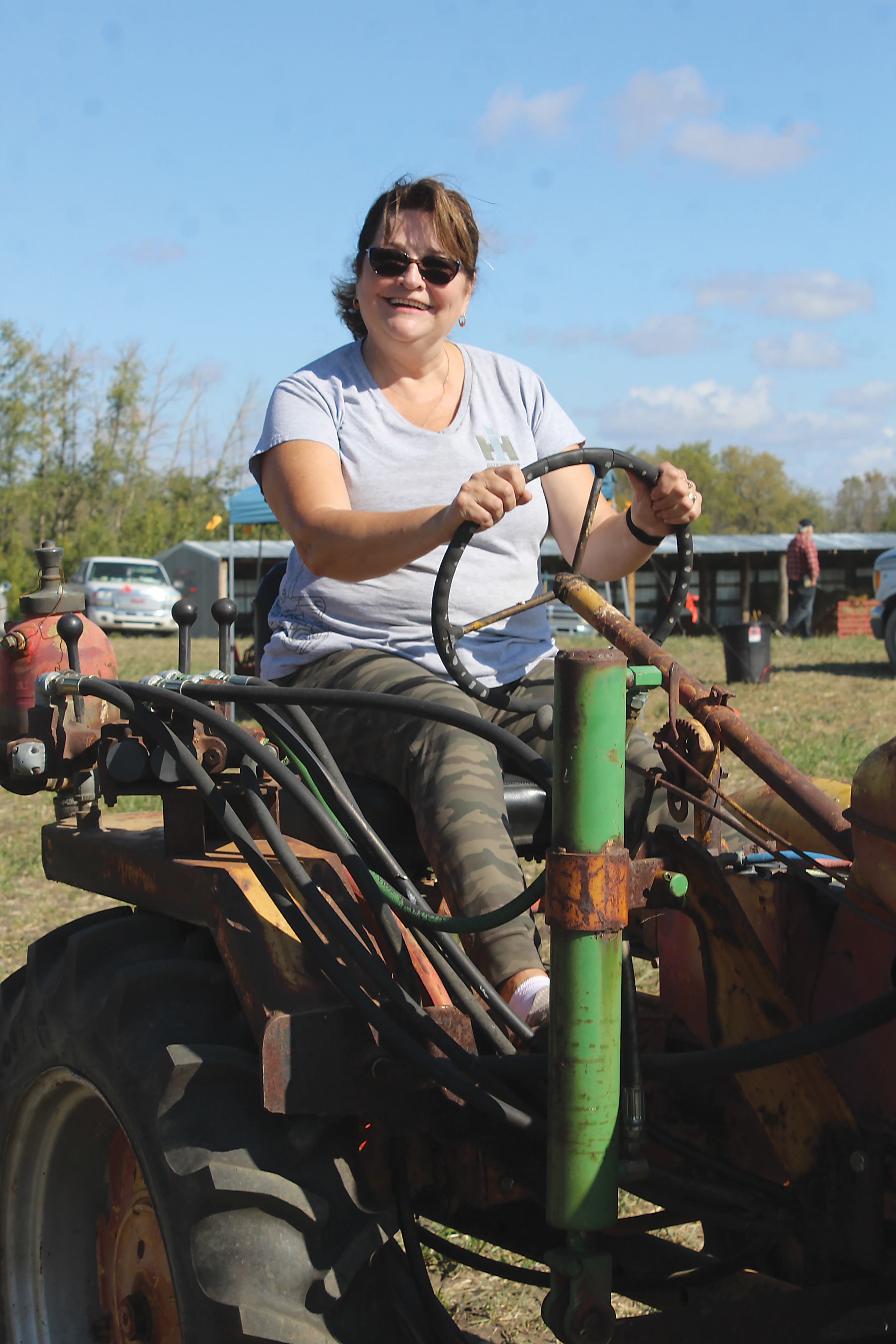 Vicky Tutthill of Elkhorn driving an antique tractor.