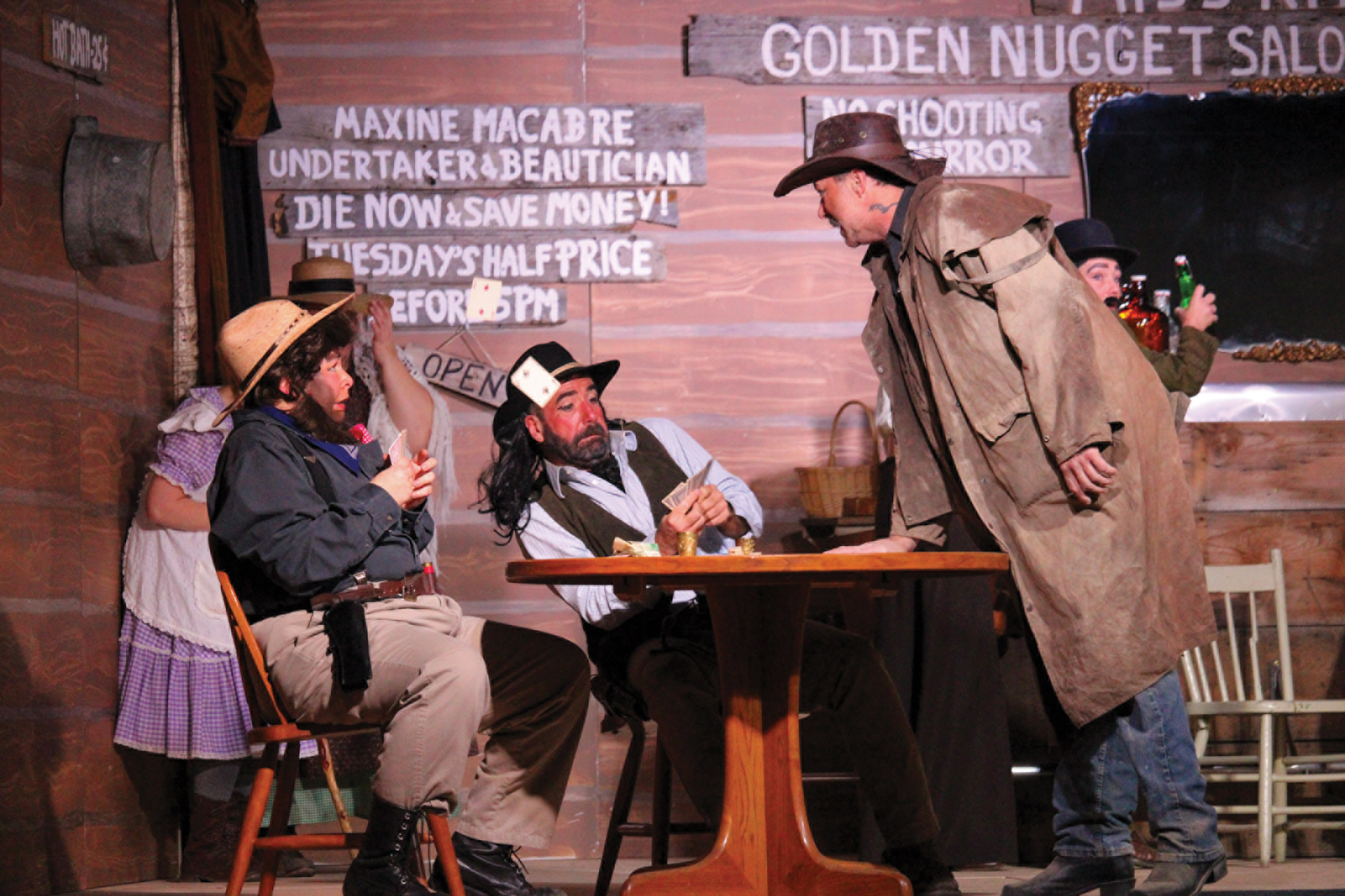 The cast of the Redvers Adult Drama Club performing The Day Black Bart Balderdash and Dangerous Dan McGrew Went to Dueling at Miss Kittys Golden Nugget Saloon.