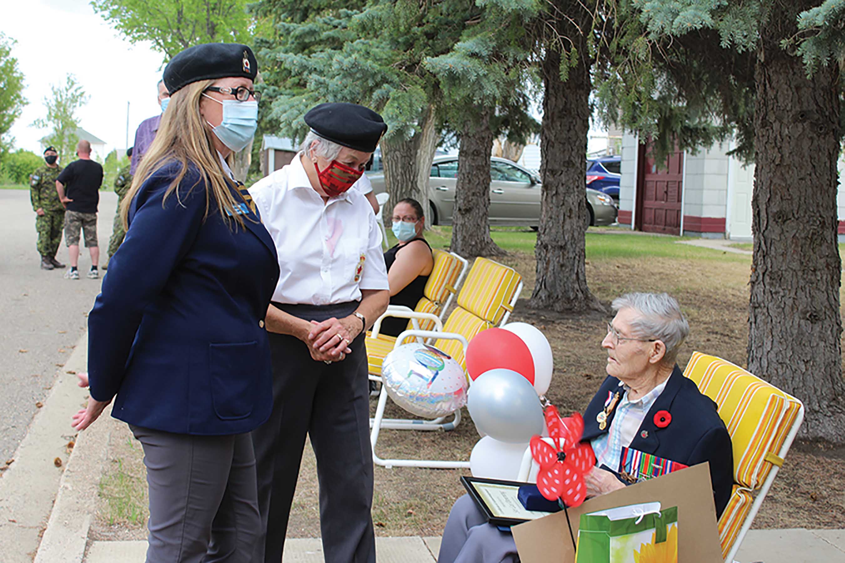 Shae Apland, left, President of Virden Legion branch and Joan Wright, right, District 2 RCL Commander, and Les Downing receiving recognition gifts for his 100 birthday and a lifetime of Royal Canadian Legion support.