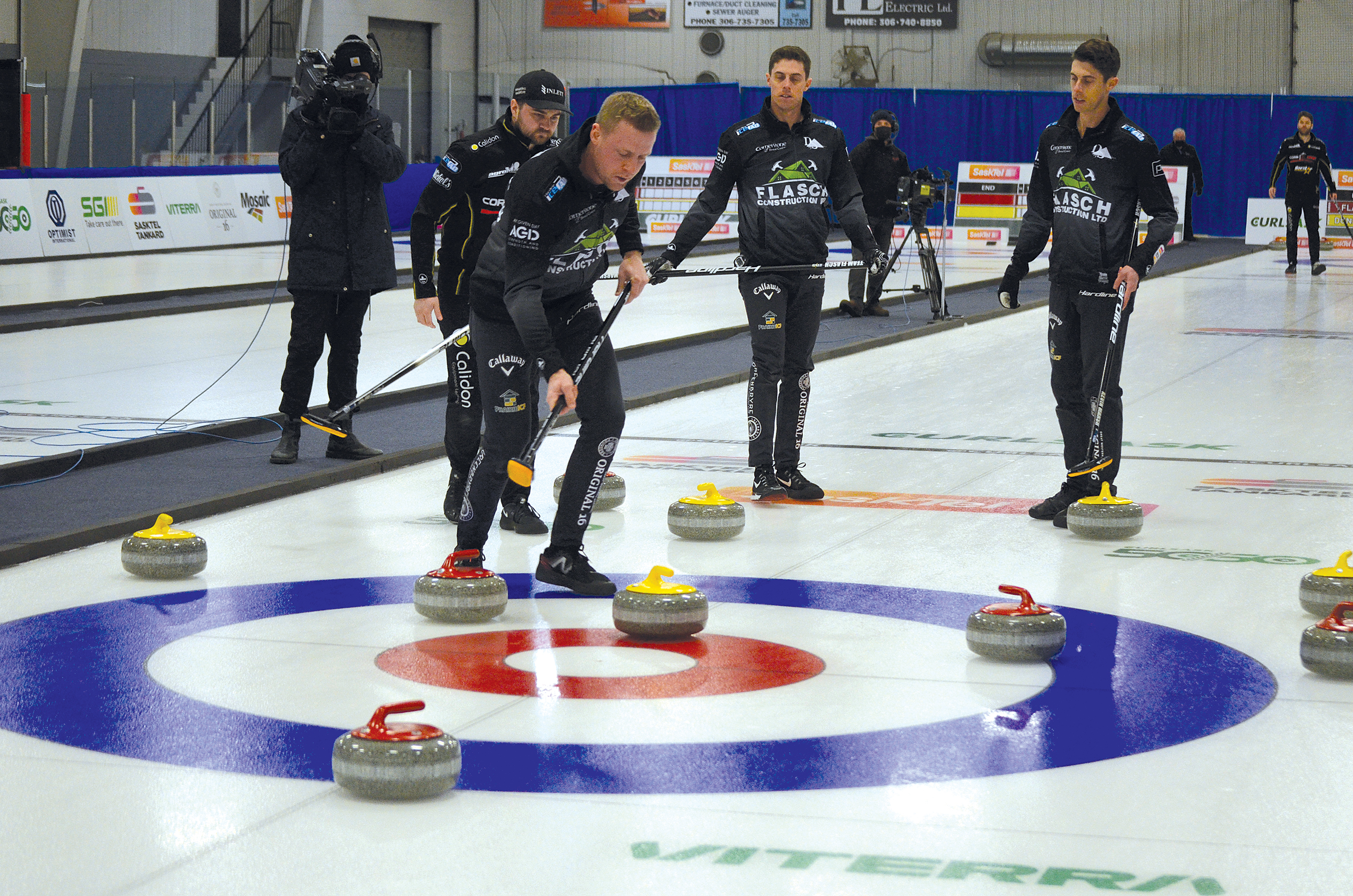 Coach Colton Flasch is ready to sweep his opponent’s rock as it rolls into the ring during the playoff game at the Tankard in Whitewood on Feb. 13. Skip Matt Dunstone (behind Flasch) and Kevin Marsh and Daniel Marsh of Team Flasch look on. Flasch went on to win the game 6-4 over Matt Dunstone’s rink.