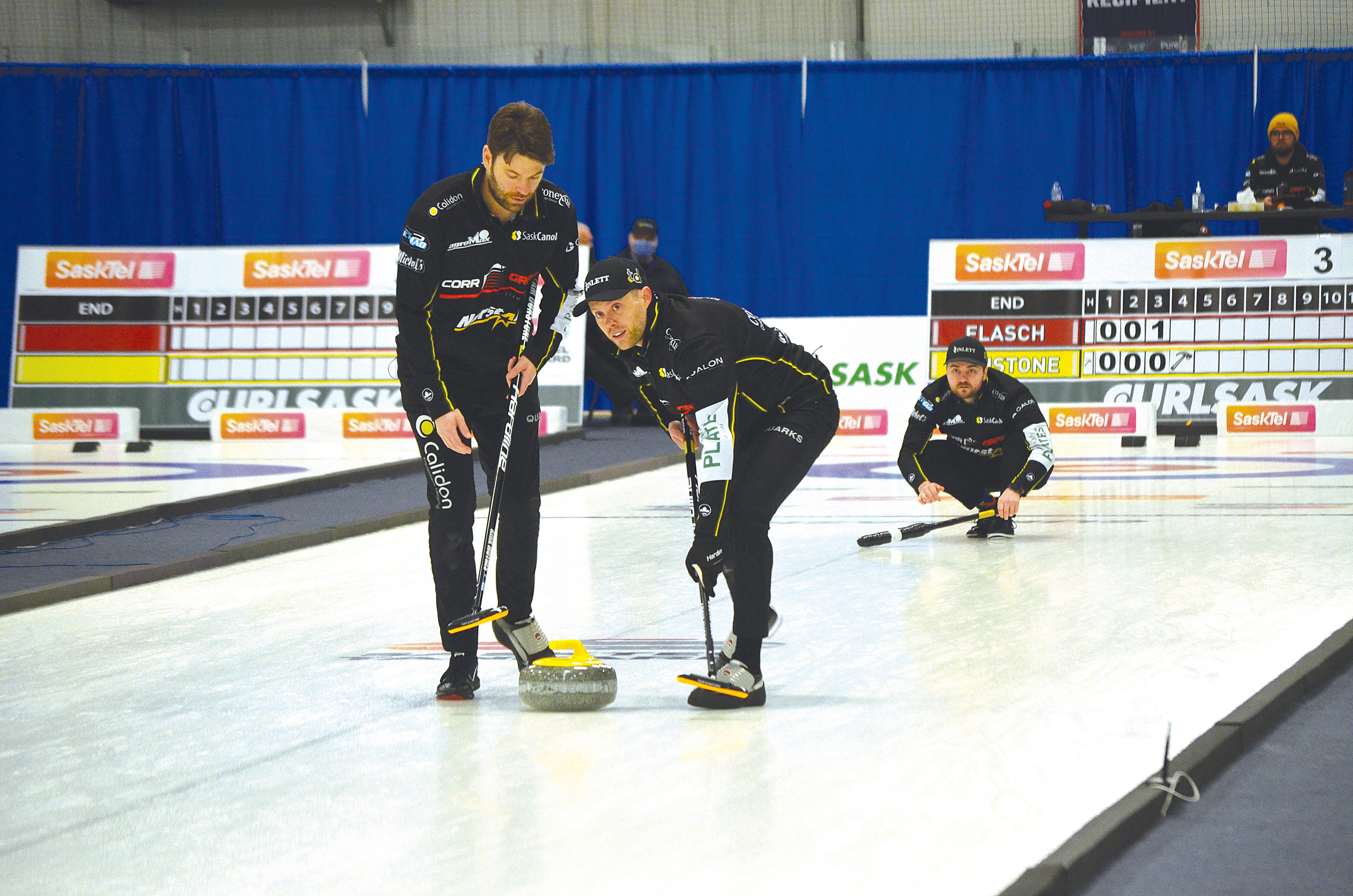 Skip Matt Dunstone’s rock is swept by his second, Kirk Muyres, left, and his lead player, Dustin Kidby early in the final game played against the Colton Flasch team in Whitewood during the Feb. 9-13 SaskTel Tankard. Dunstone’s team lost to Flasch when Dunstone’s final rock failed to net him what he needed to lead his team to victory.