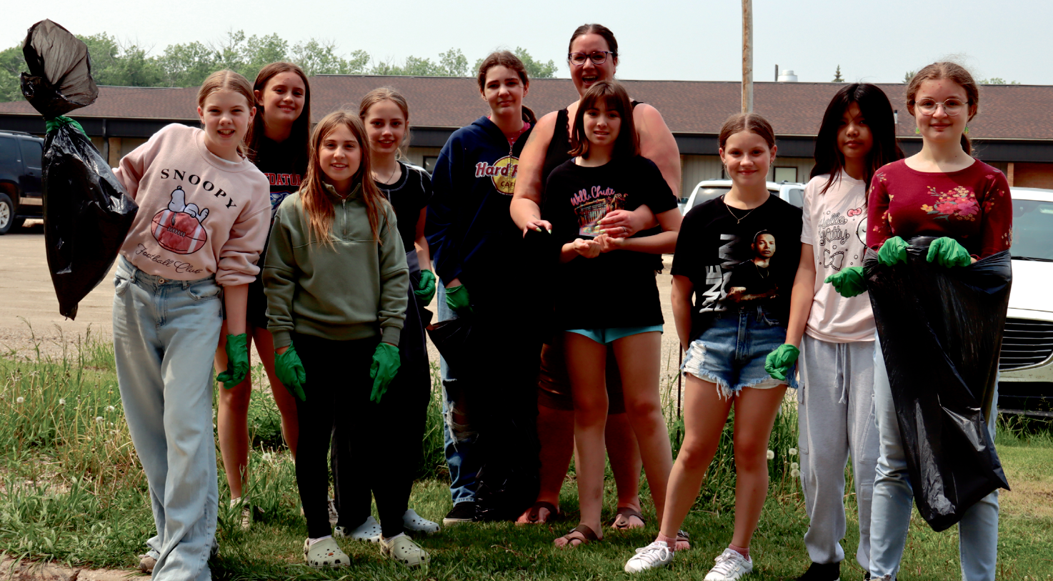 High school students outside of MacLeod Elementary School for the town clean-up last year.