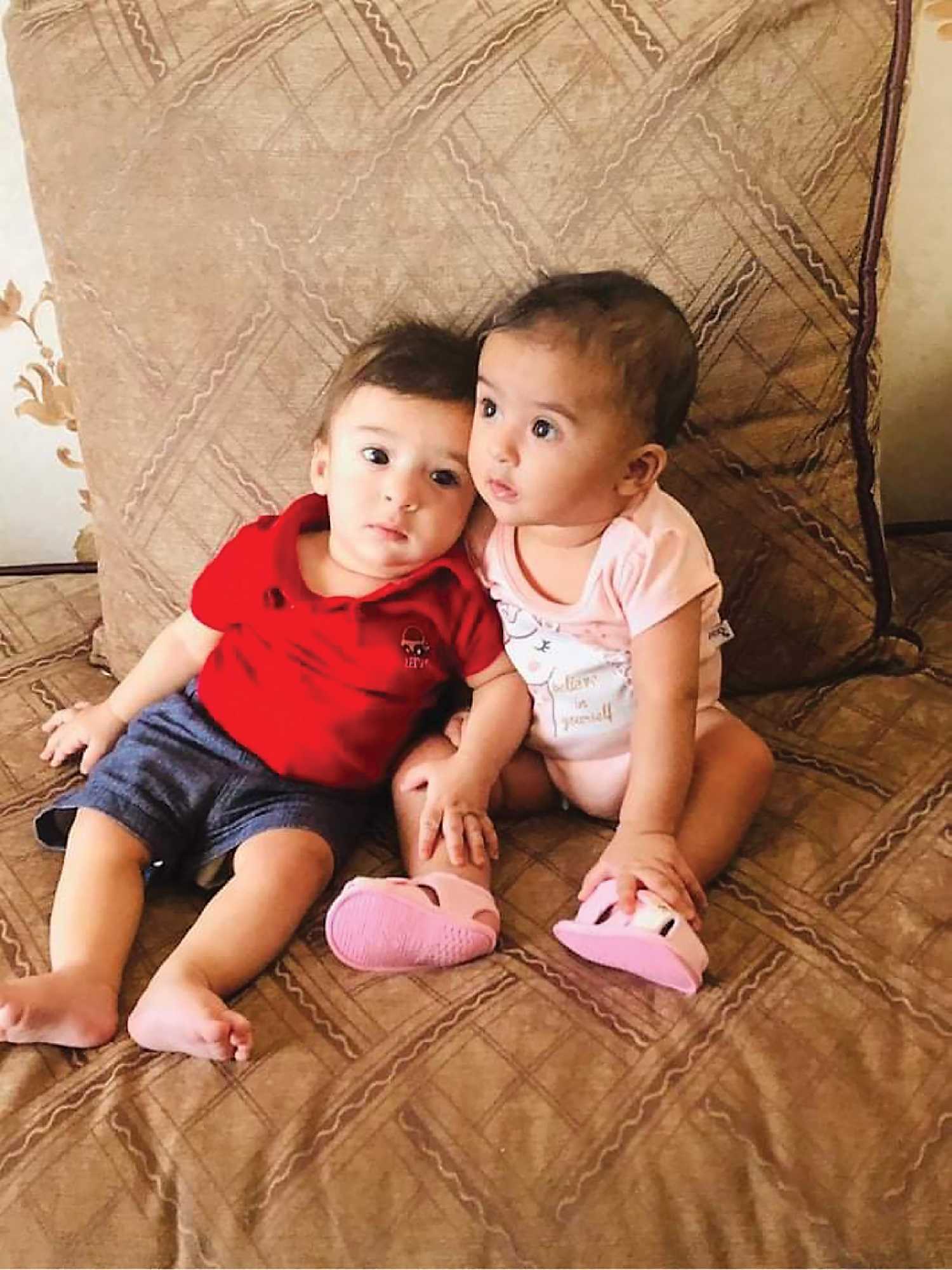 The seven-month-old twins of the interpreter who is one step closer to making it to Canada with his family.