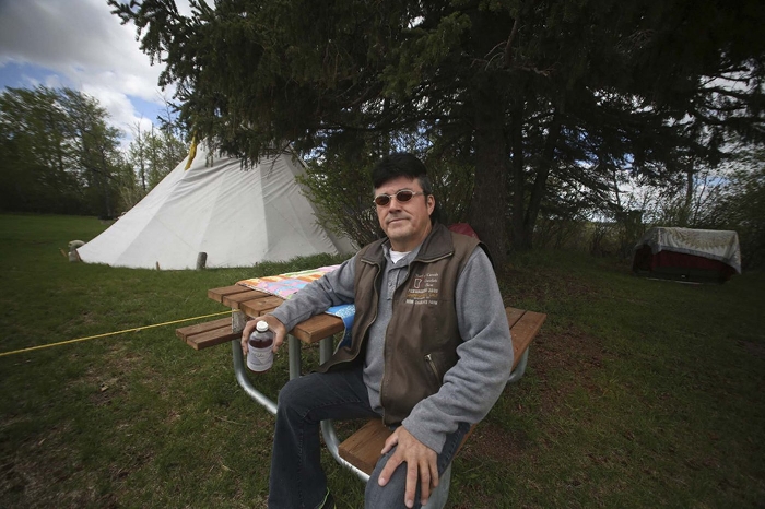 Wesley Bone poses near the teepee he erected at Riding Mountain National Park.