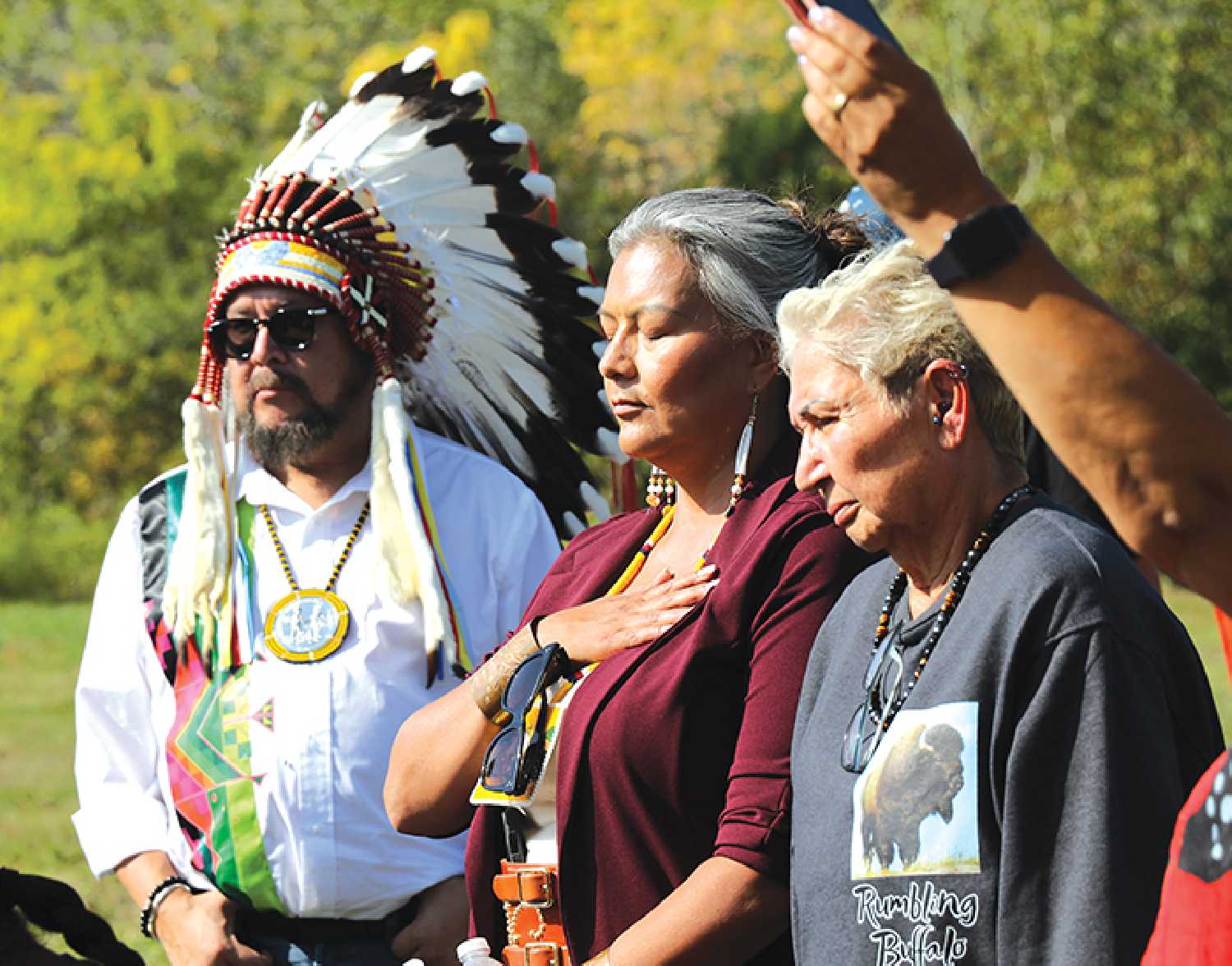 Chief Jonathan Pasap, and councillors of White Bear First Nations gather to listen to drums.