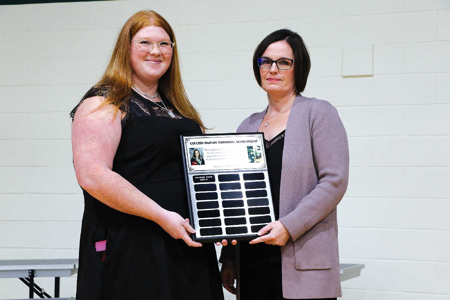Annabelle Korth is presented with the Colleen McPhee Memorial Scholarship by Wendy Ireland of MNP Moosomin.