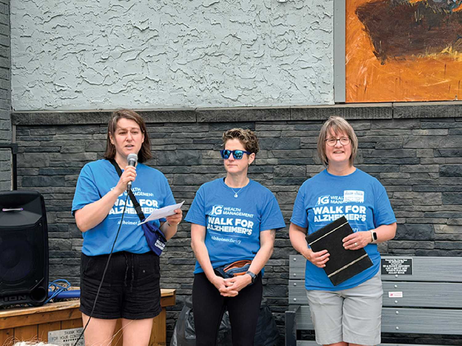 Above at left, Kelsey Nagy of IG Wealth Management Moosomin, Maureen Harrison of the Alzheimer�s Society of Saskatchewan, and Rene Whelpton of Moosomin Alzheimer�s Society, speaking at the walk on Saturday, May 30. At right, some of the walkers at this year�s 